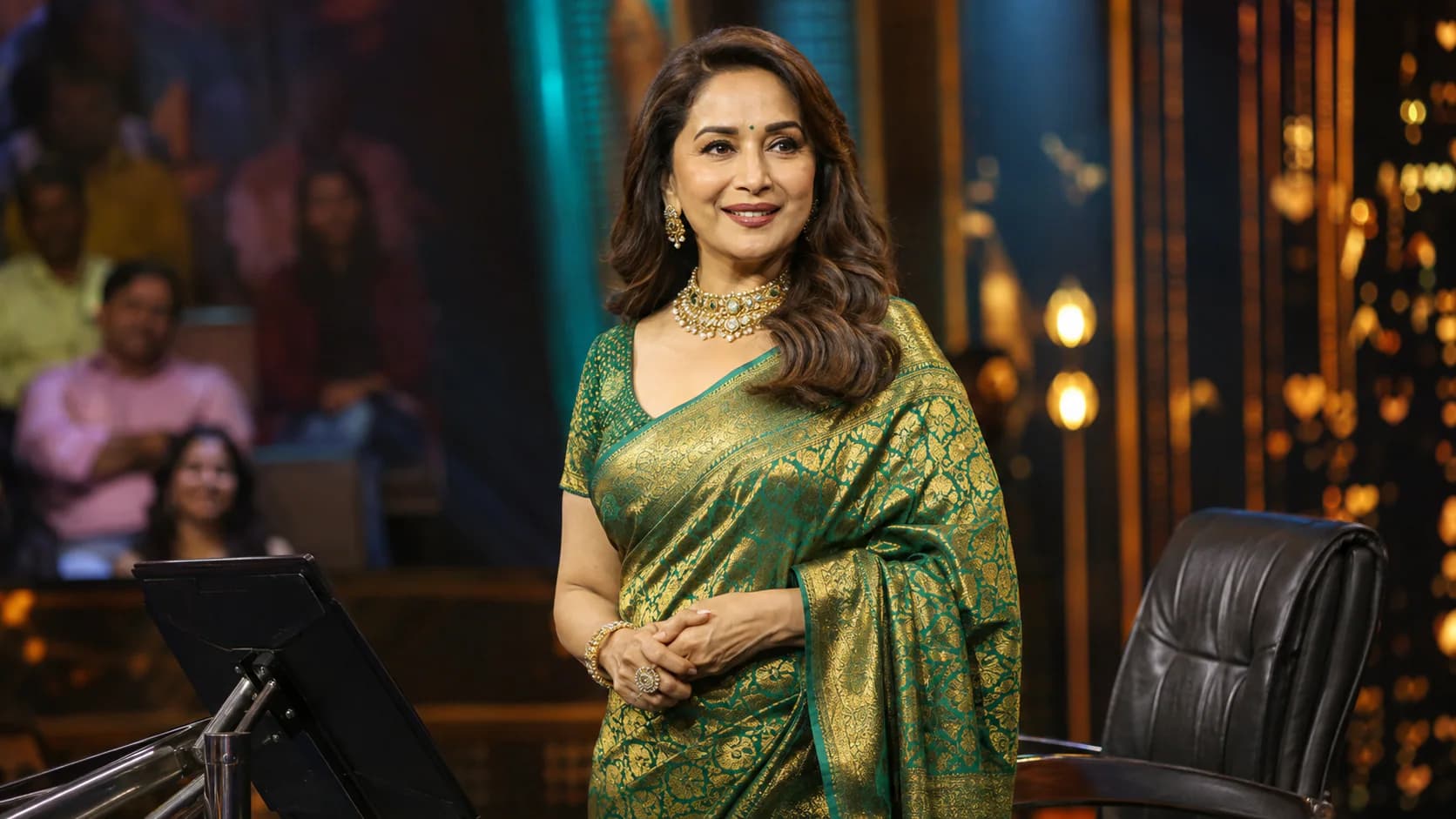 Madhuri Dixit stands on a television quiz-show stage as she returns to hosting with Marathi programme Kon Honar Crorepati.