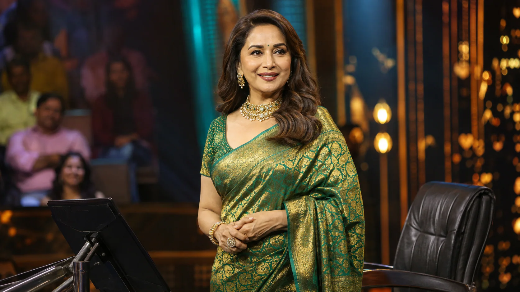 Madhuri Dixit stands on a television quiz-show stage as she returns to hosting with Marathi programme Kon Honar Crorepati.